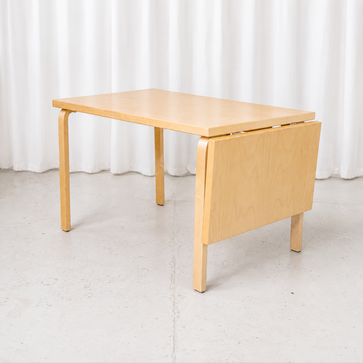 Classic Artek drop-leaf table by Alvar Aalto with a practical extendable design.