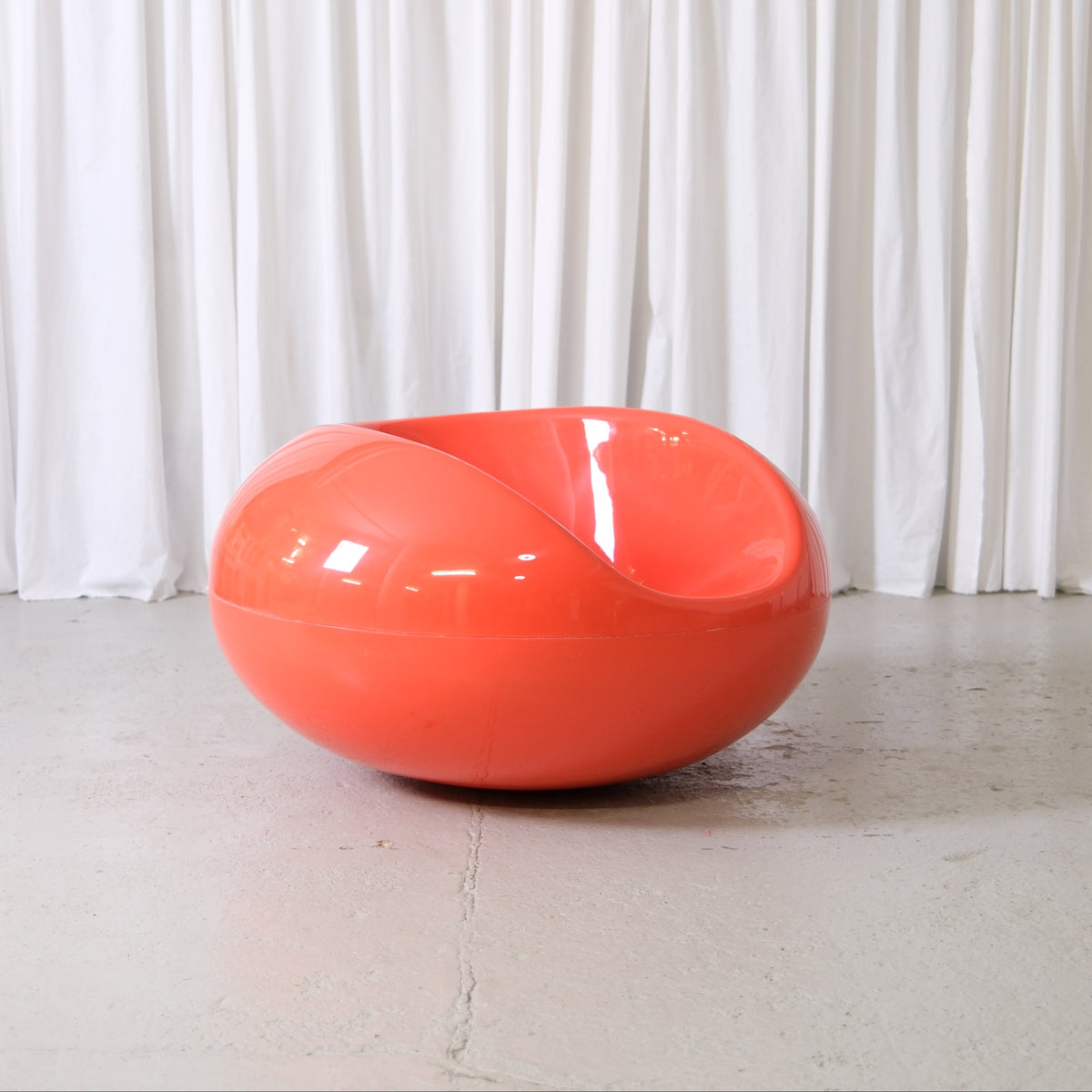 Eero Aarnio Pastilli chair in orange glossy fiberglass, Finnish Space Age design lounge chair photographed at Pino Interiors Helsinki.