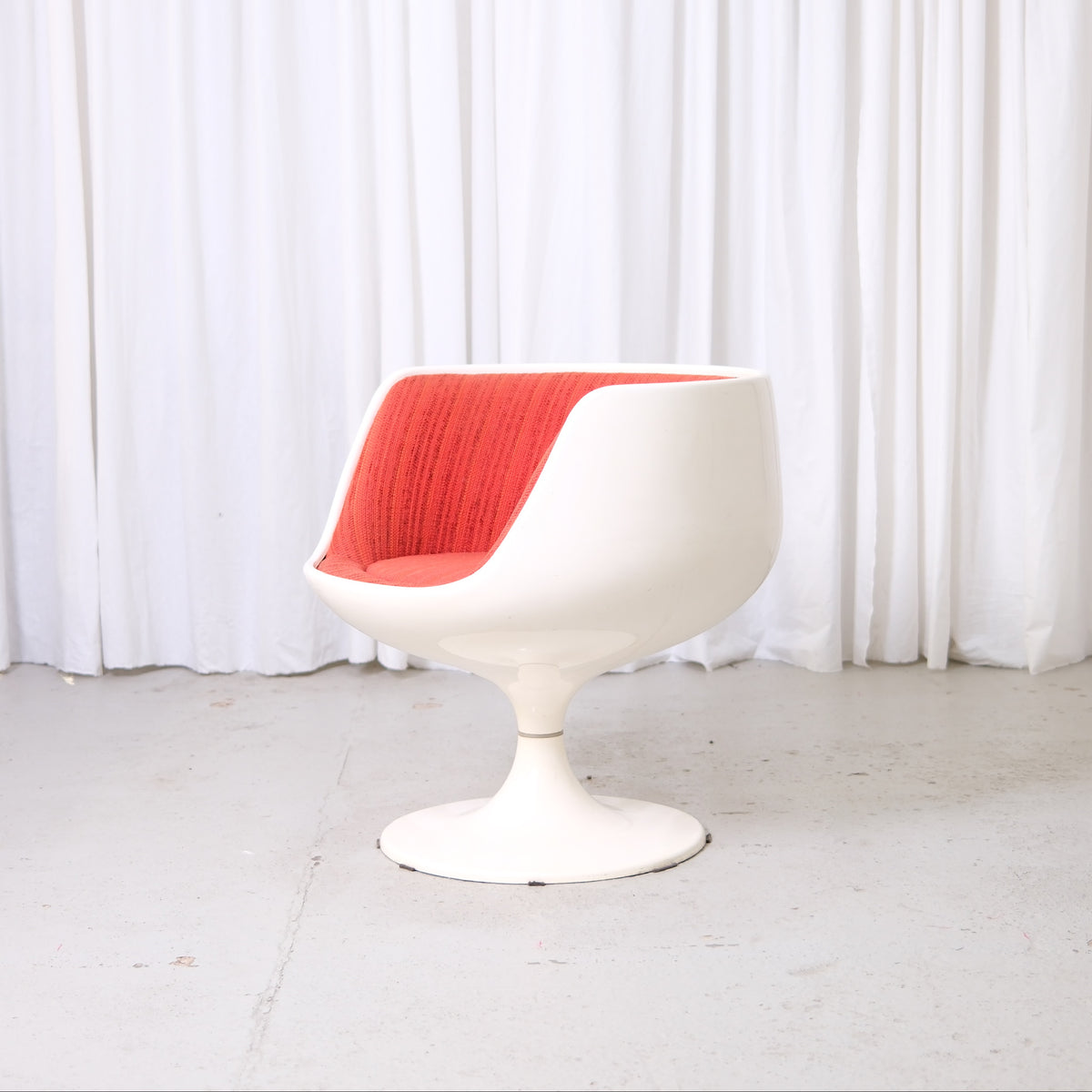 Eero Aarnio Cognac chair with red fabric interior and tulip pedestal base