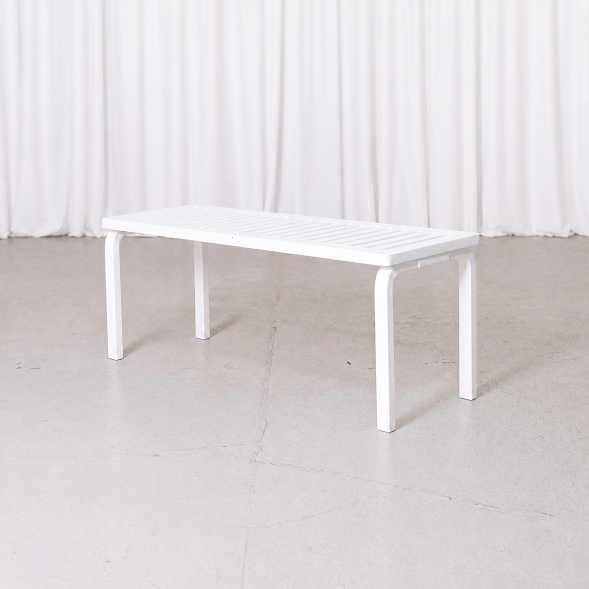 White Artek 153A slatted bench by Alvar Aalto, three-quarter view