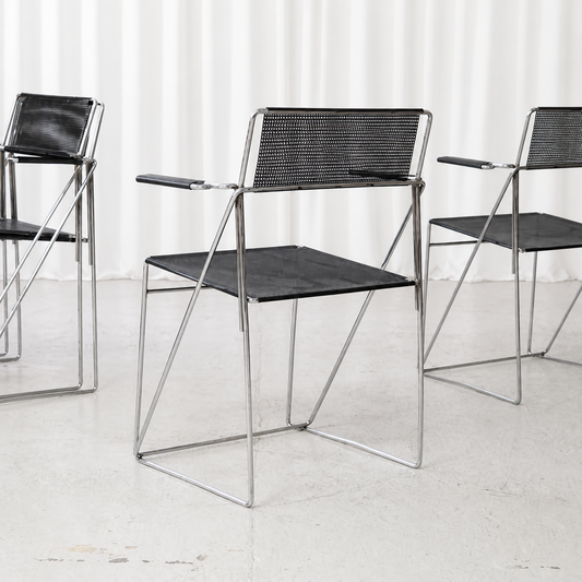 Black and chrome Hybodan X-Line armchair with perforated steel seat and back