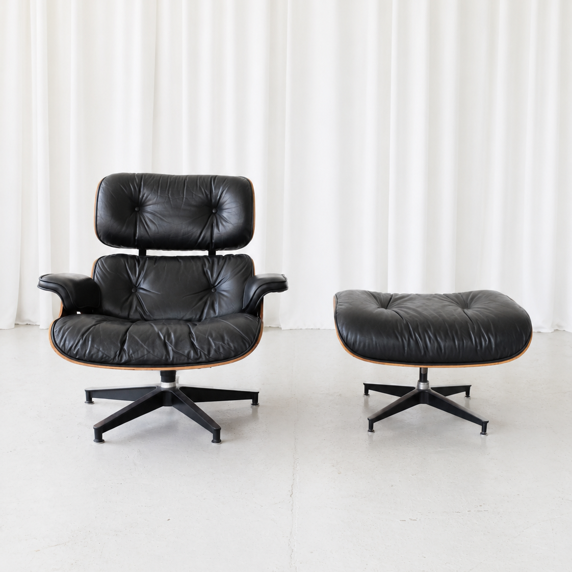 Eames Lounge Chair -lepotuoli ja rahi, ruusupuu ja musta nahka, valmistaja Herman Miller